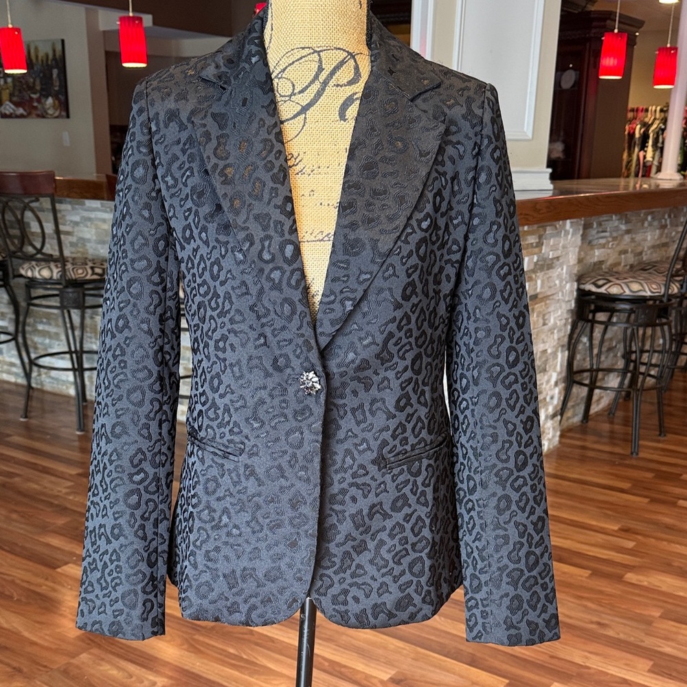 Aqua size small black leopard print with one rhinestone button closure